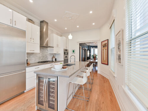 Kitchen of 99 Willcocks Street featuring built-in wine fridge in island