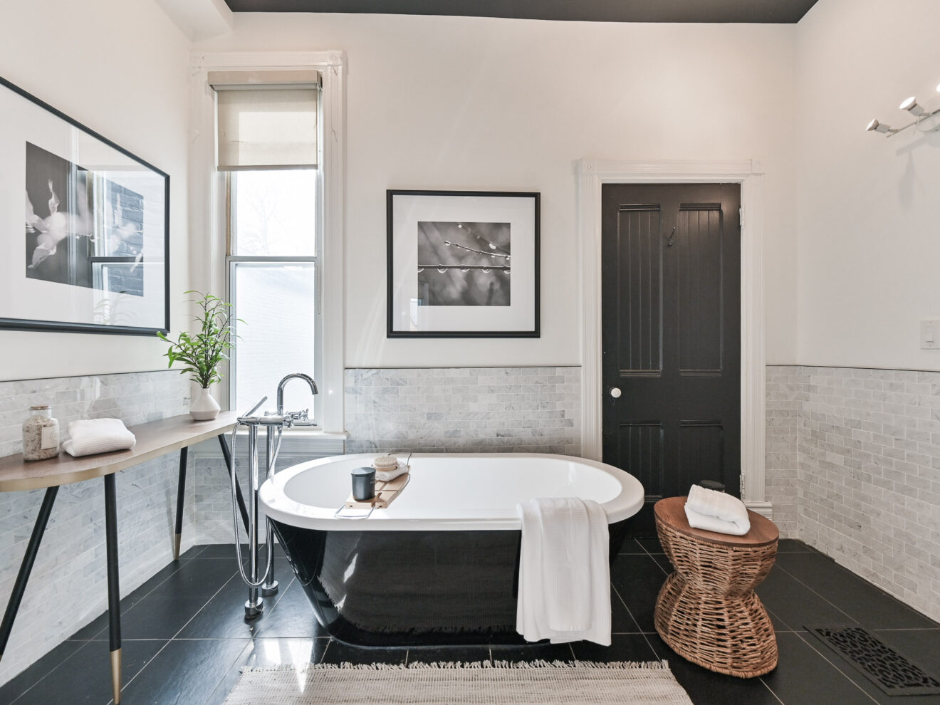 Master bathroom of 99 Willcocks Street featuring tub and bright window