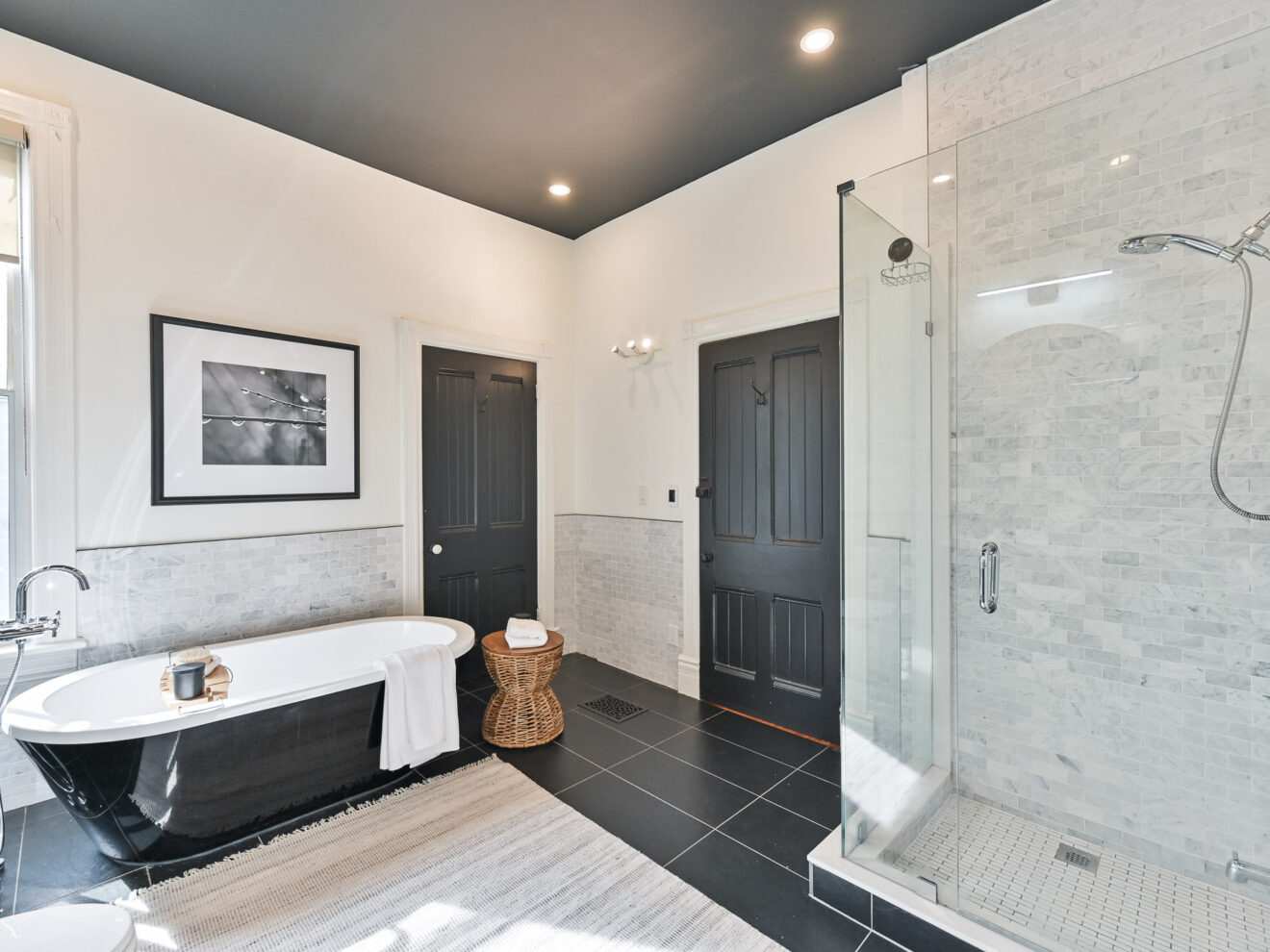 Master bathroom of 99 Willcocks Street featuring tub and glass-door shower